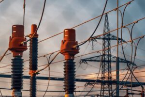 Detailed view of power transformers and lines against a suns