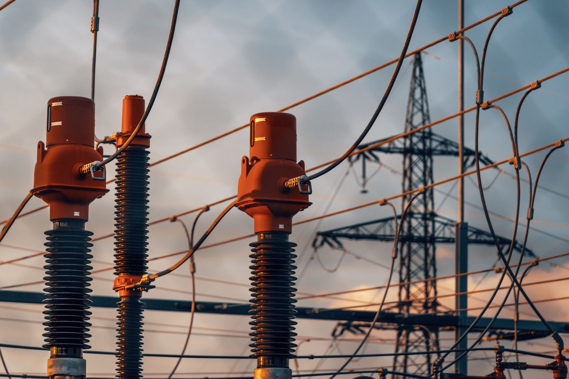 Detailed view of power transformers and lines against a suns
