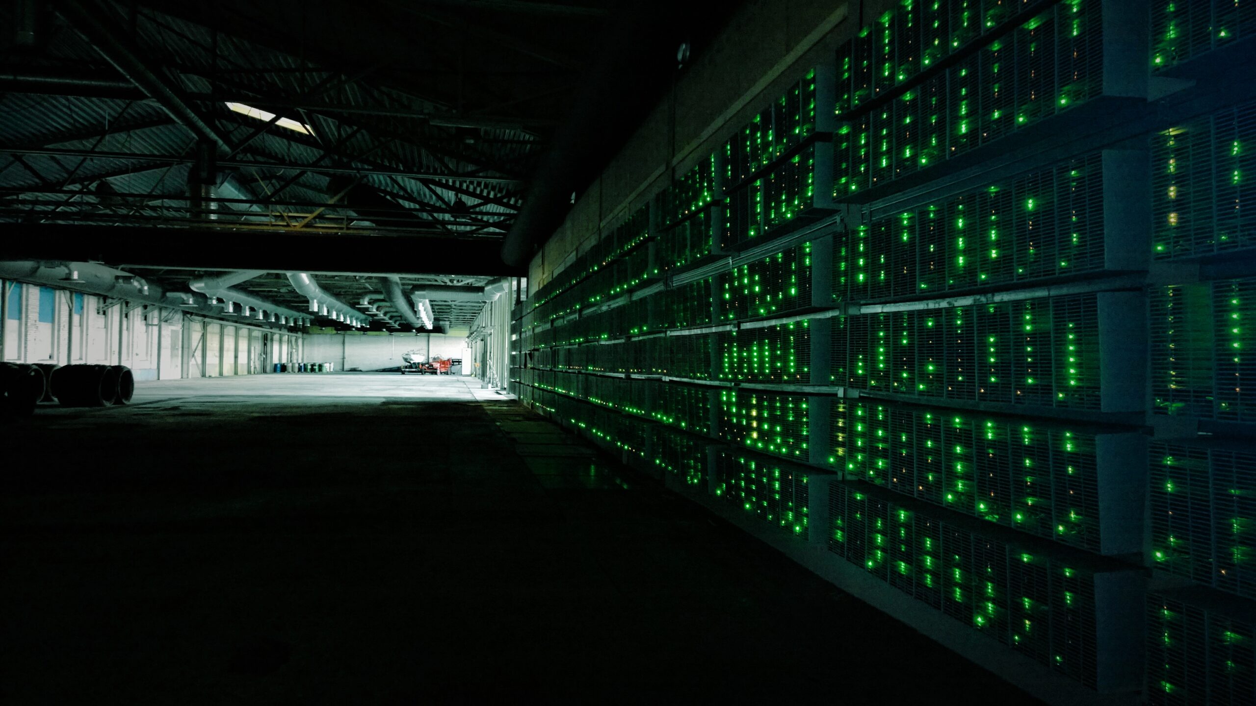 Bitcoin mining farm with rows of ASIC mining hardware - Photo by Marko Ahtisaari CC BY 2.0