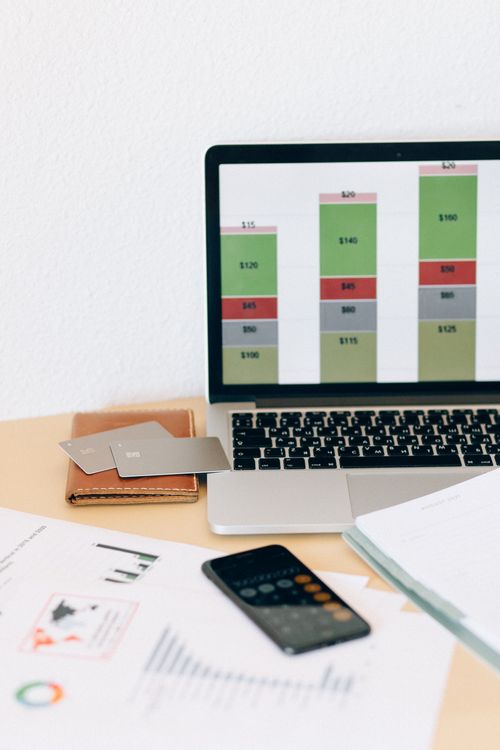 Financial accounting workspace with laptop displaying charts and documents for bitcoin mining bookkeeping