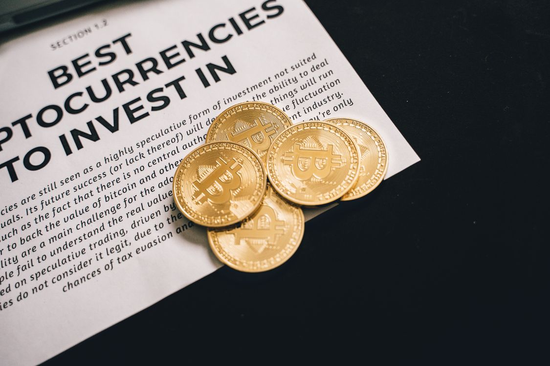 Bitcoin coins on financial documents representing mining pool payouts and revenue calculations