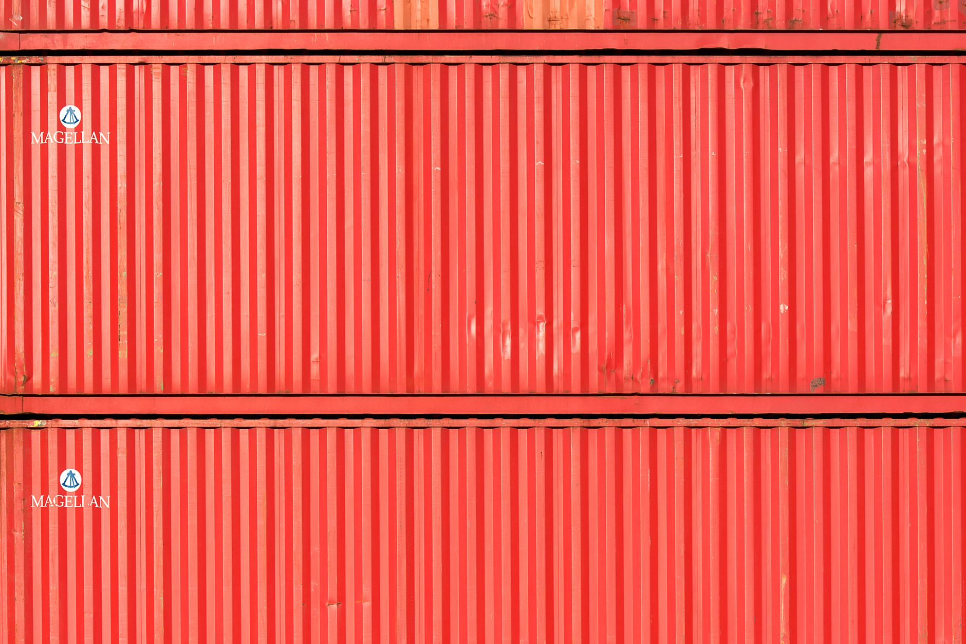 Close-up of stacked red cargo containers, providing a vibran