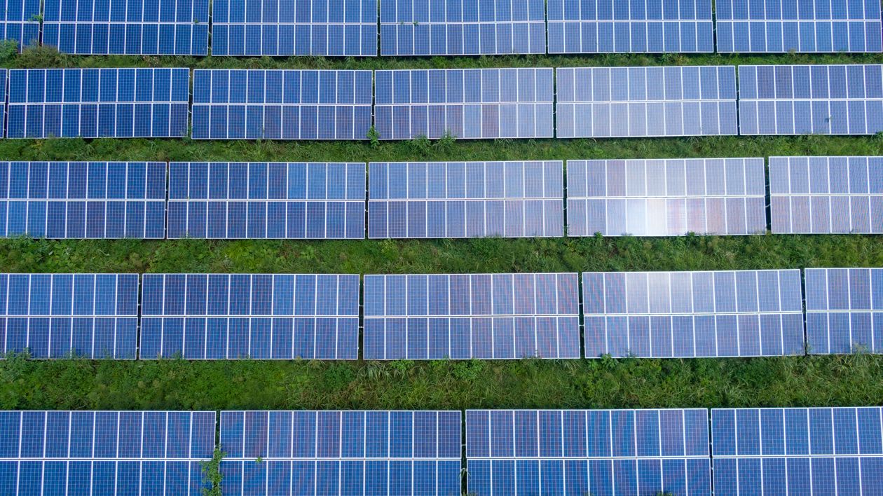 Wind turbines and solar panels representing environmental compliance for Bitcoin mining facilities