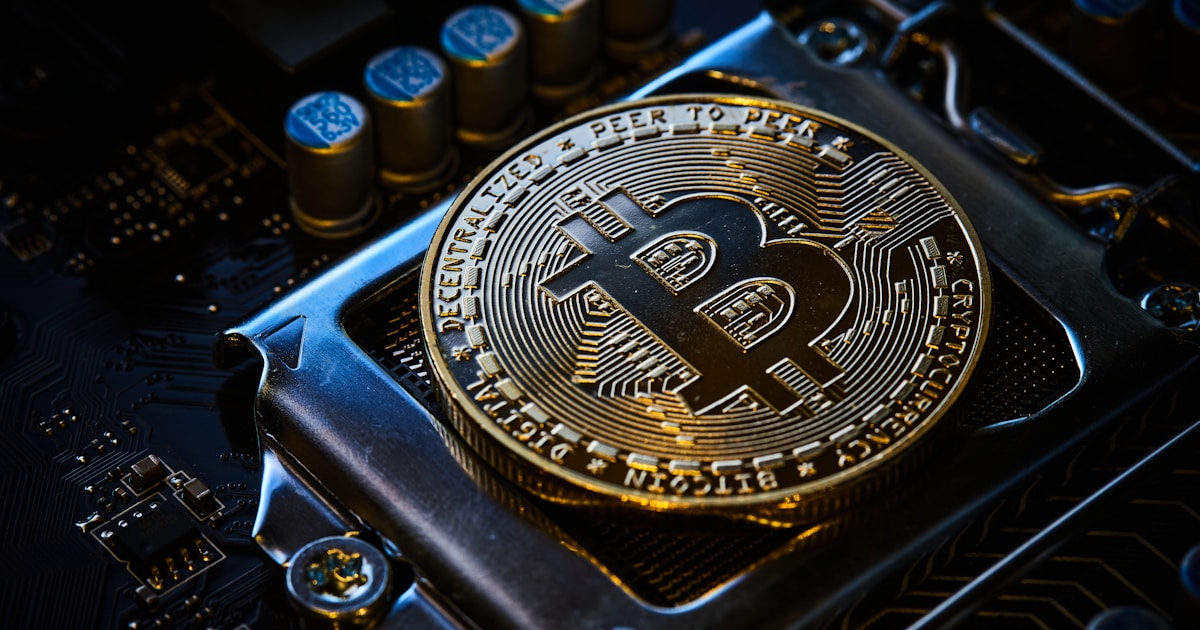 Bitcoin cryptocurrency on a computer motherboard representing ASIC miner hardware purchasing decisions