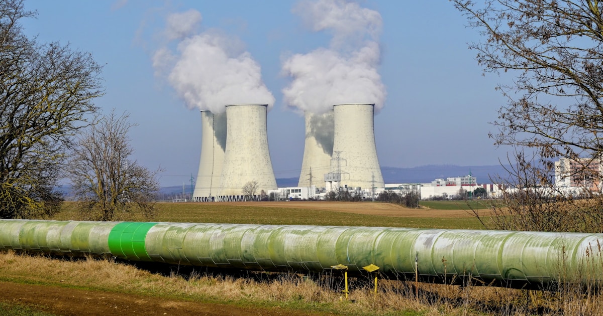 Cooling towers emitting steam at an industrial facility used for Bitcoin mining heat rejection