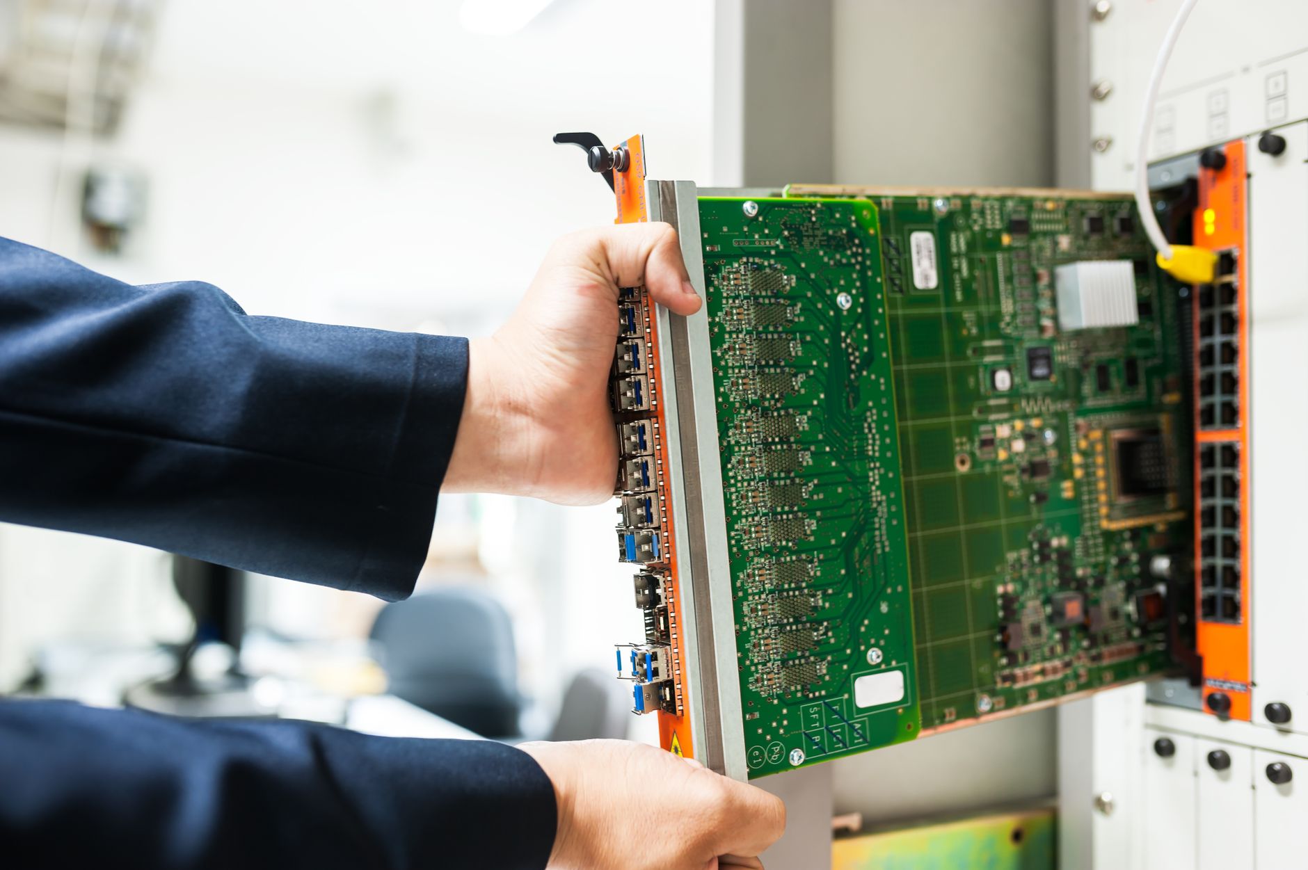 Technician inspecting ASIC mining hardware in a data center rack as part of a predictive maintenance program